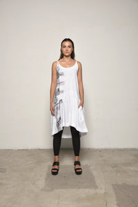 White linen peplum dress by SIMPLY MILA Modern Women's Clothing, front view showing fitted waist and flared skirt.