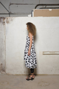 Linen peplum dress from SIMPLY MILA featuring a stylish modern design with a dotted pattern, side view.