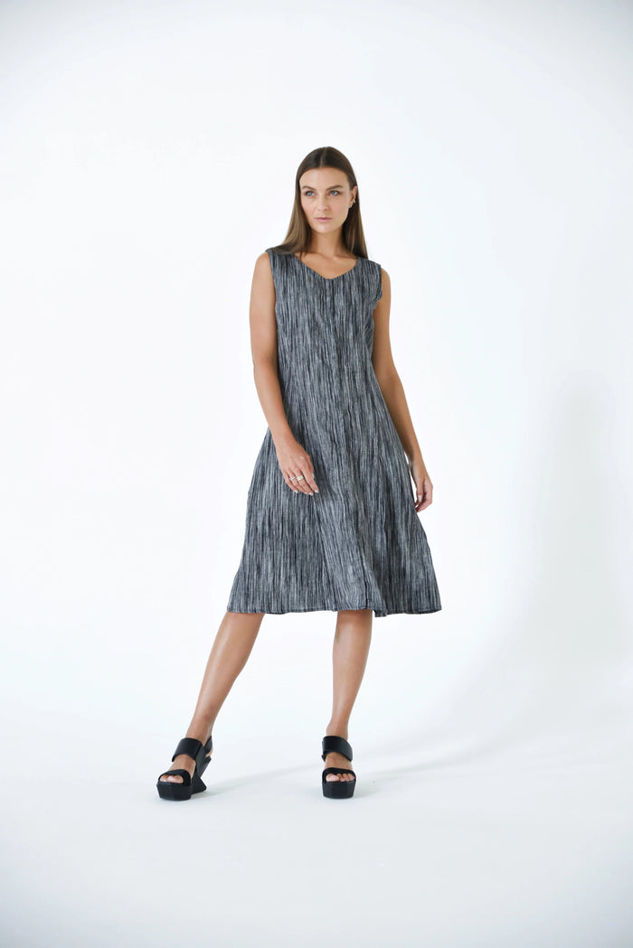 SIMPLY MILA Lisbon Dress displayed on a hanger, featuring a stylish, modern women's dress with a flowing design and vibrant color.