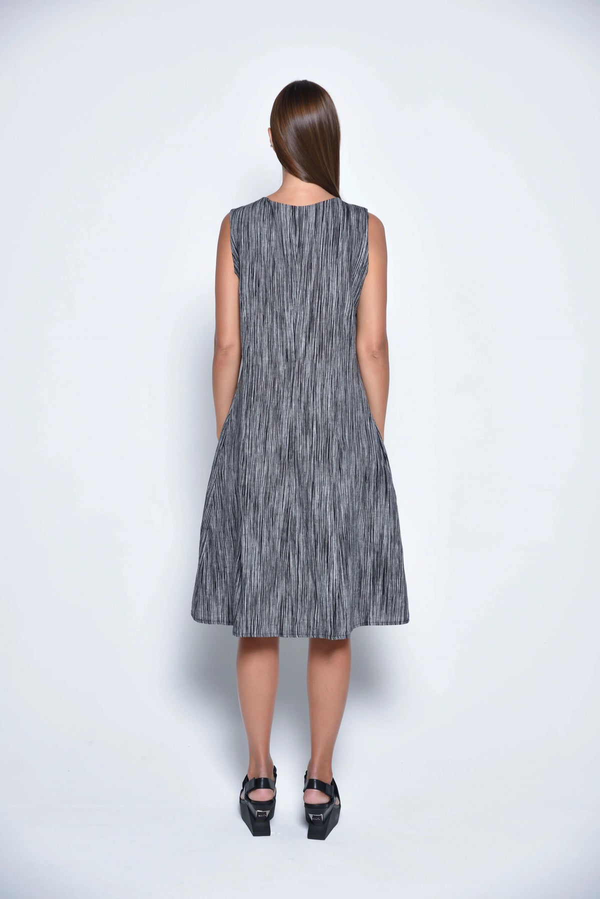 Back view of the SIMPLY MILA Lisbon Dress, a stylish women's dress with a flowing silhouette and modern design.