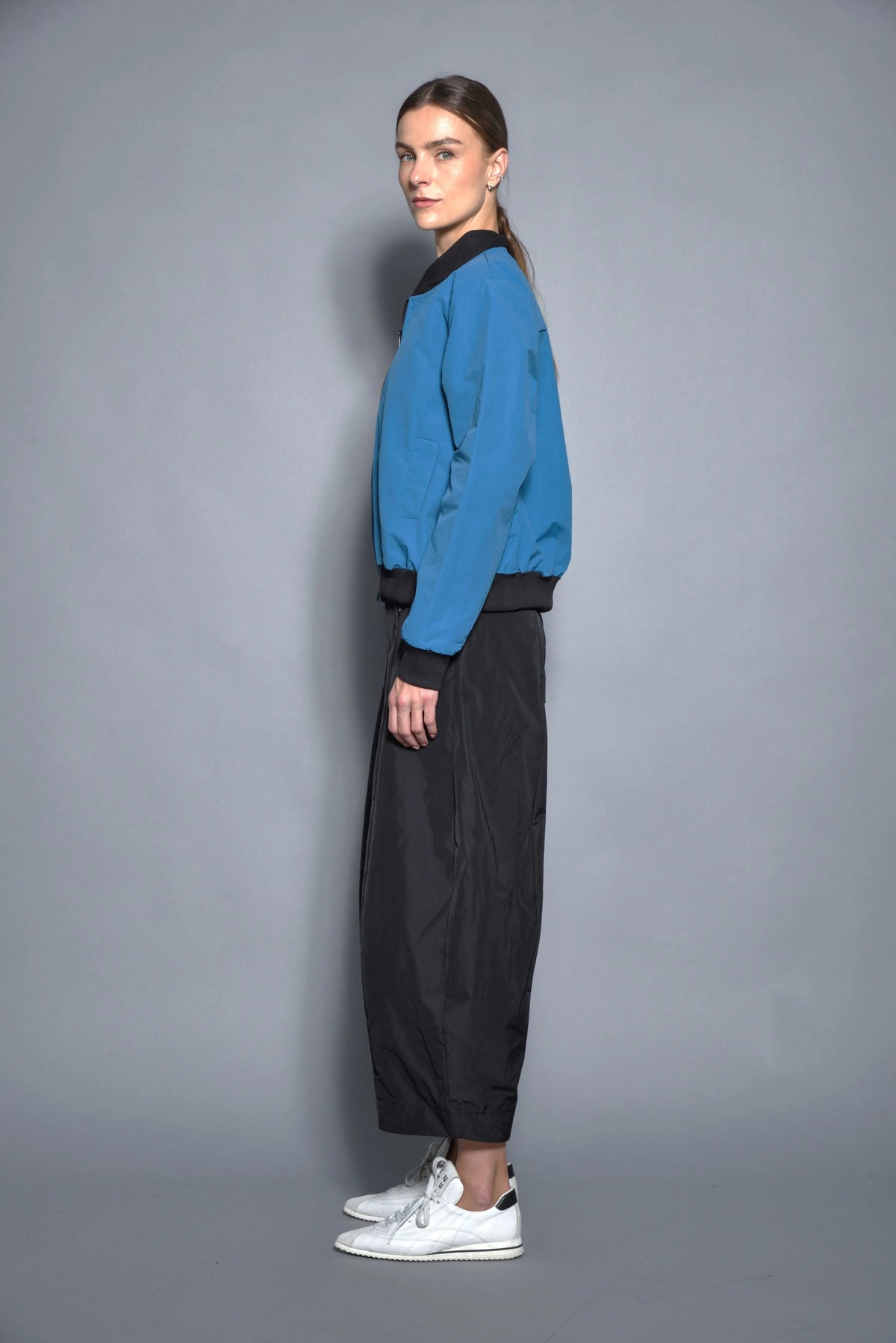Simply Mila modern women's baseball jacket with contrast sleeves and snap buttons, shown in a stylish casual look.