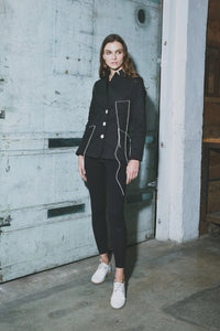 Simply Mila Baste Stitch jacket, modern women's clothing, close-up of stylish black jacket with stitched details and collar.