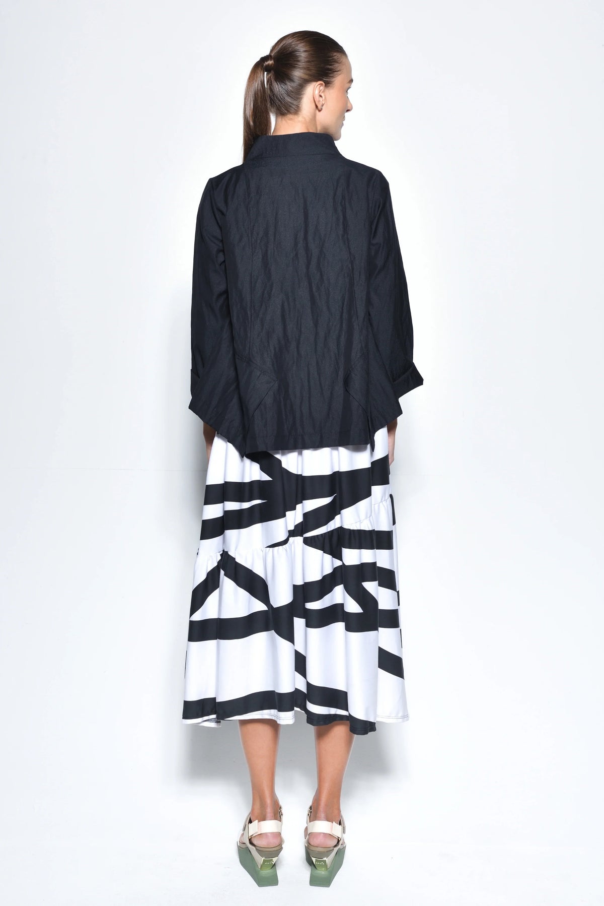 Black Tokyo jacket by SIMPLY MILA, modern women's outerwear with a stylish, tailored fit, displayed on a hanger.