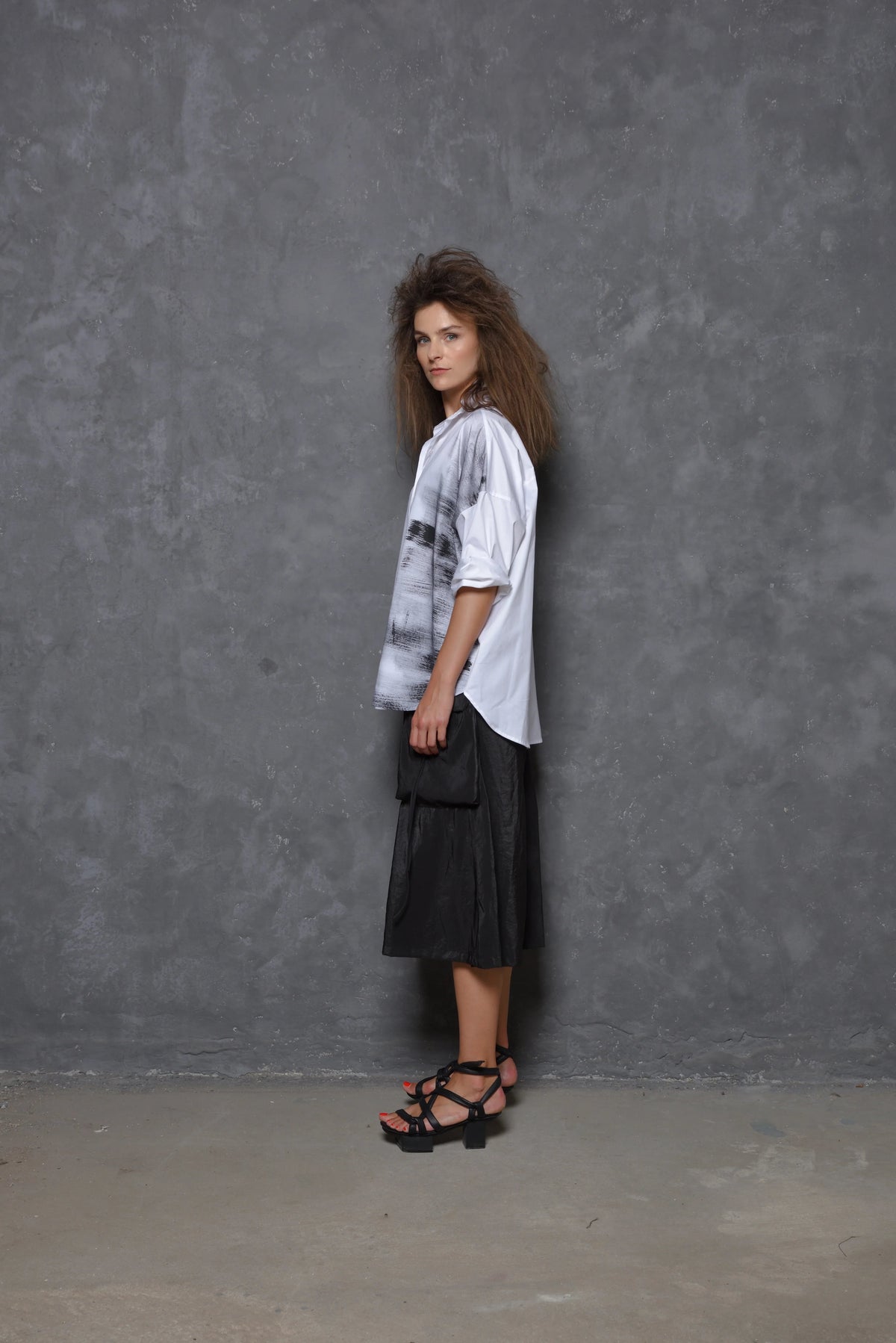 Side view of a white Stroke Boxy Shirt by SIMPLY MILA, modern women's shirt with a relaxed fit and clean design.
