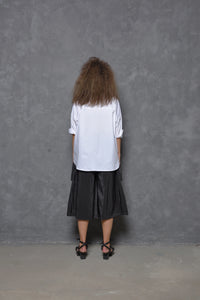 Back view of a black Stroke Boxy Shirt for women by SIMPLY MILA, featuring a relaxed fit and modern design.