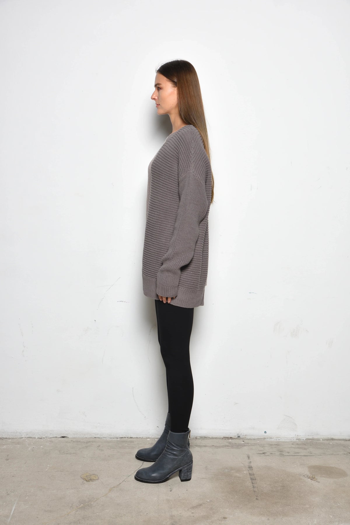 Side view of a Portobello Sweater by SIMPLY MILA, a modern women's clothing sweater in soft knit fabric with ribbed cuffs.