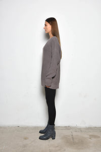 Side view of a Portobello Sweater by SIMPLY MILA, a modern women's clothing sweater in soft knit fabric with ribbed cuffs.