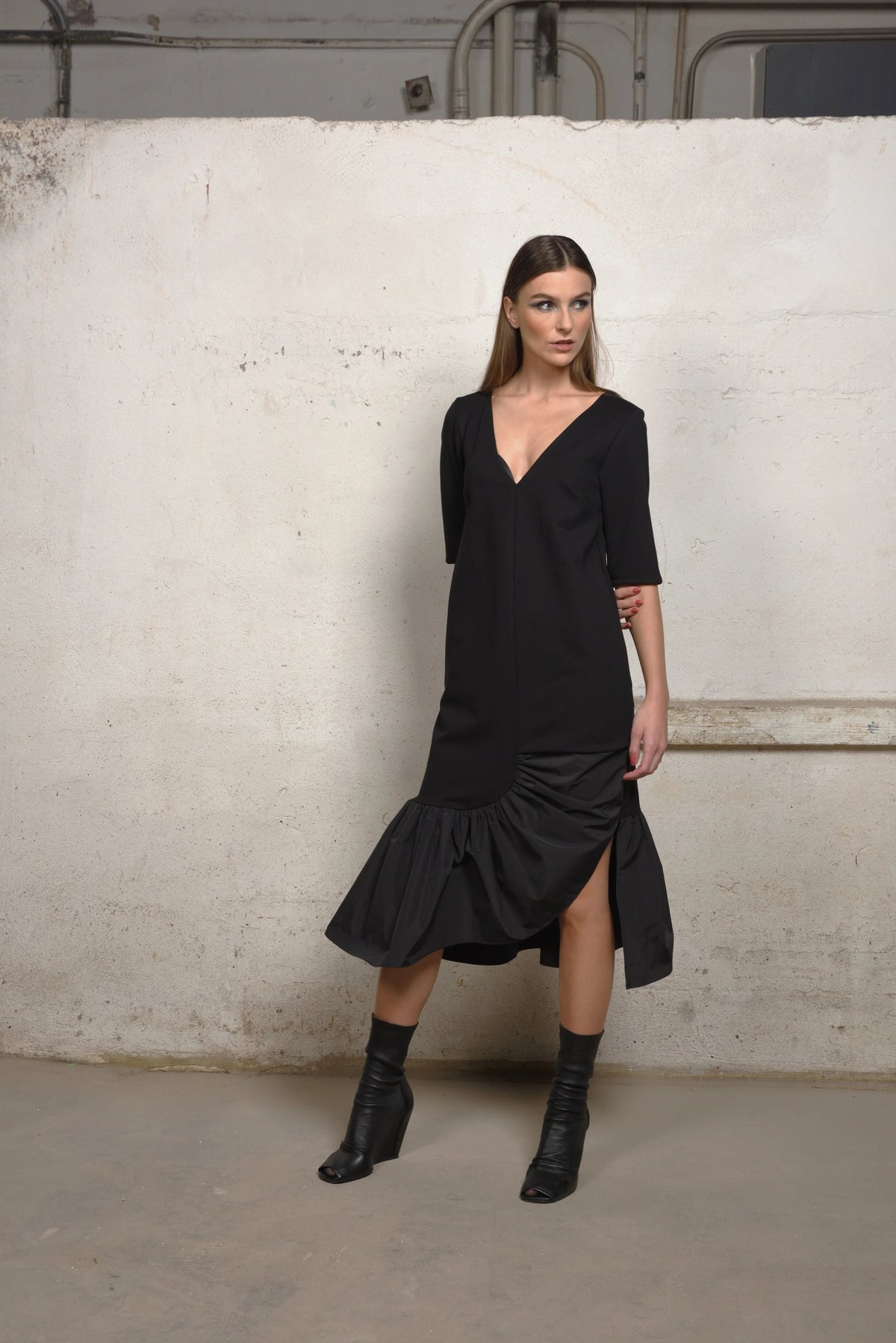 Simply Mila unbalance ruffle sweater dress showcasing a stylish, modern women's sweater with ruffle details and a relaxed fit.