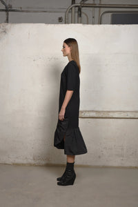 Side view of a SIMPLY MILA Unbalance Ruffle sweater dress featuring ruffled details and a modern women's clothing style.