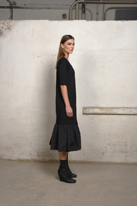 Side view of a simply styled unbalance ruffle sweater dress by SIMPLY MILA, featuring a relaxed fit and ruffle details.