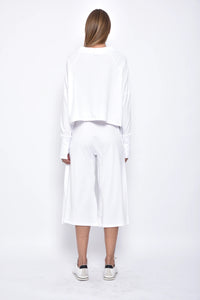 Back view of a SIMPLY MILA Zoe top, a modern women's clothing blouse with stylish design and comfortable fit.