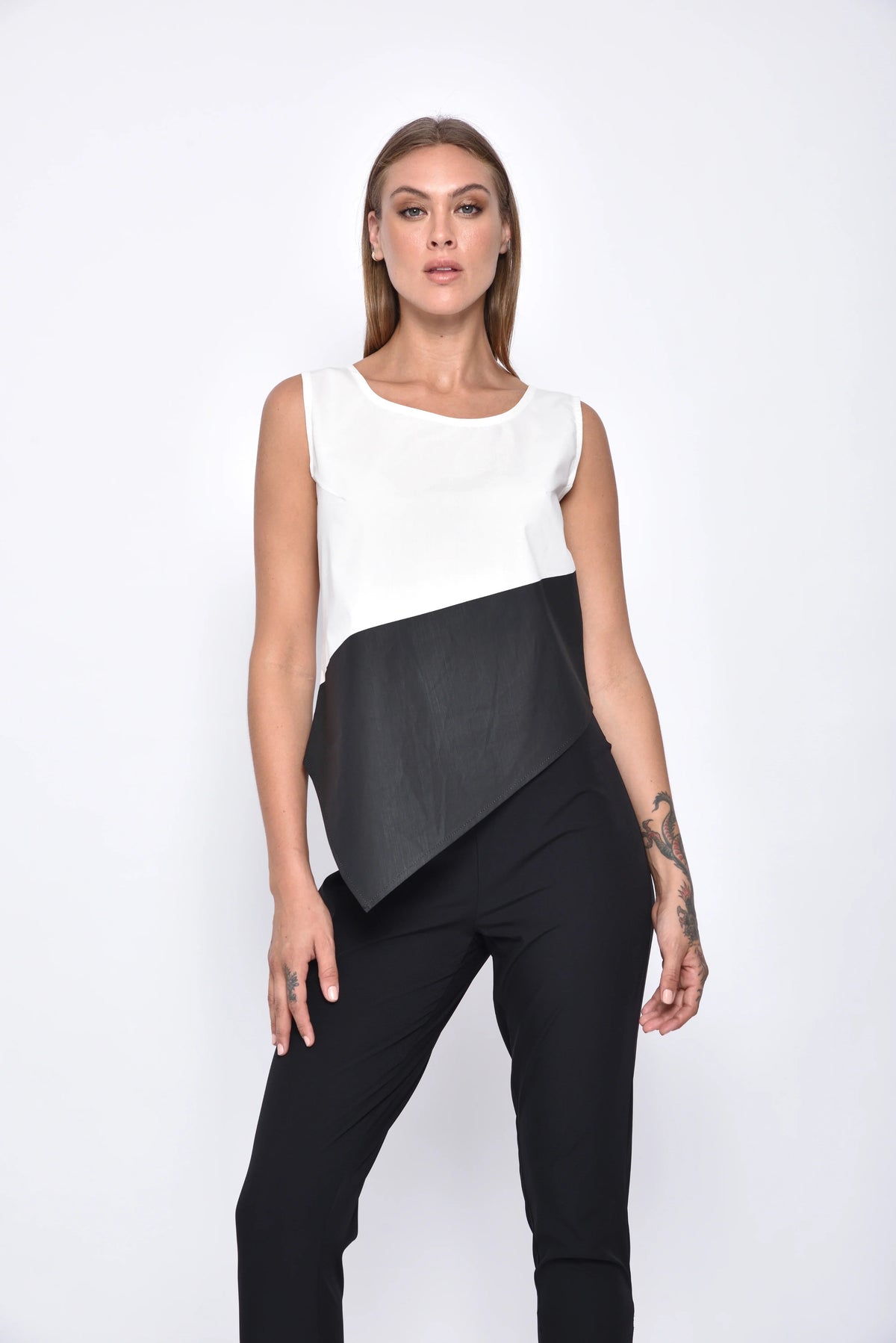 Simply Mila modern women's uneven hem tank top displayed on a hanger, showcasing its stylish irregular hem and sleeveless design.
