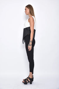 Side view of a modern women's uneven hem tank top by SIMPLY MILA, featuring a stylish, casual sleeveless design.