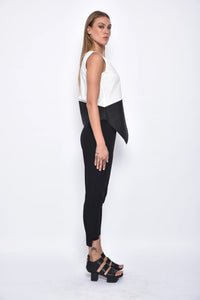 Side view of a women's uneven hem tank top by SIMPLY MILA, featuring a stylish sleeveless design and modern fit.