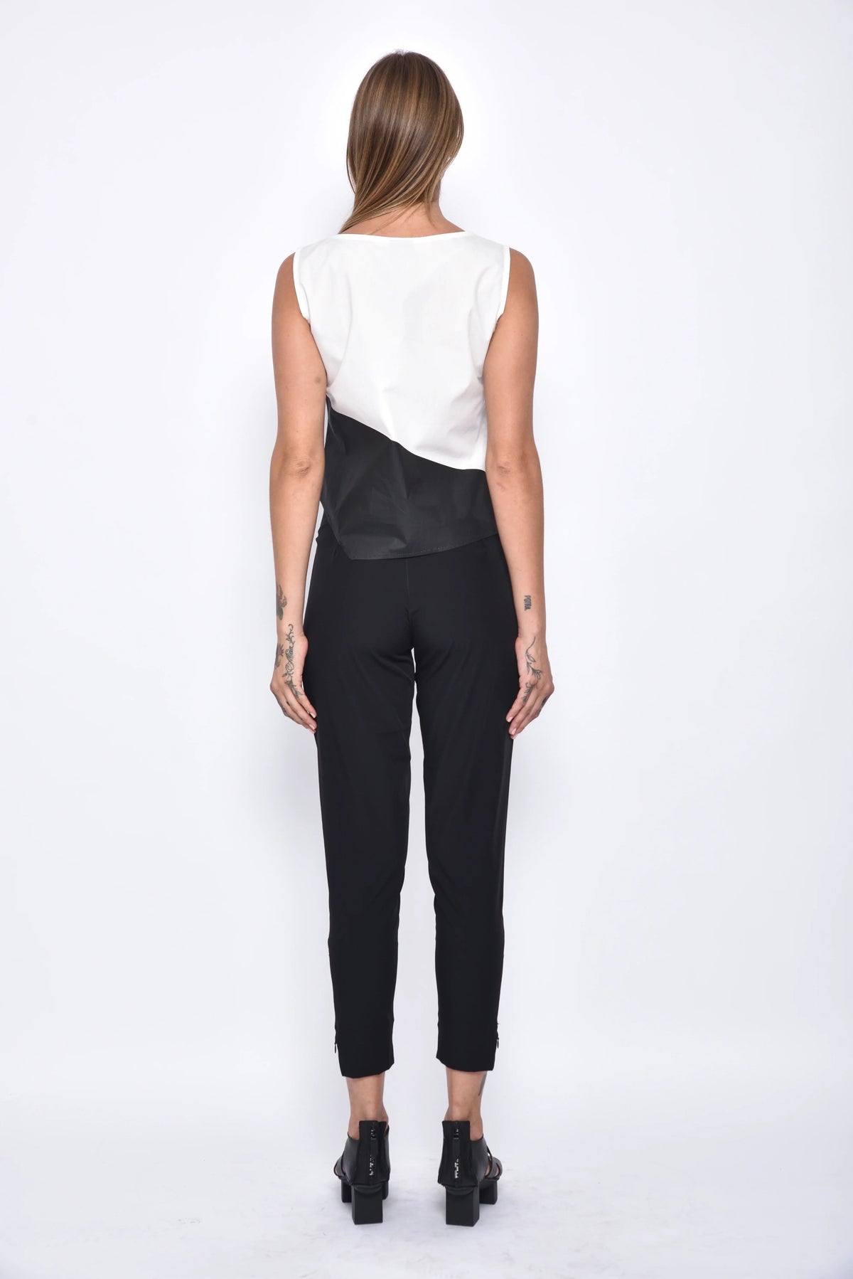 Back view of SIMPLY MILA modern women's uneven hem tank top in soft fabric, showcasing stylish asymmetrical hem detail.