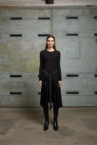Black apron top from SIMPLY MILA Modern Women's Clothing, featuring a stylish sleeveless design and adjustable straps.