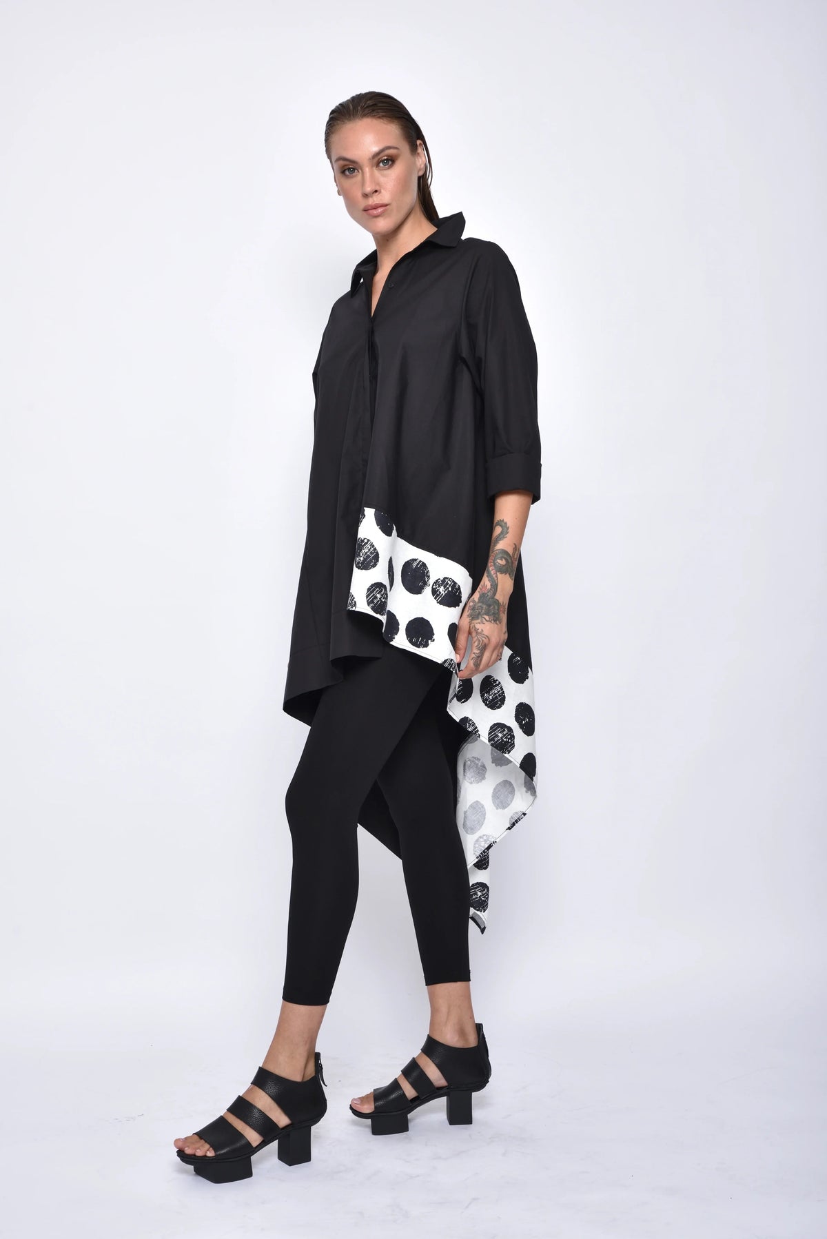 Asymmetrical tunic shirt from SIMPLY MILA, modern women's top with a stylish, uneven hem and relaxed fit, side view.