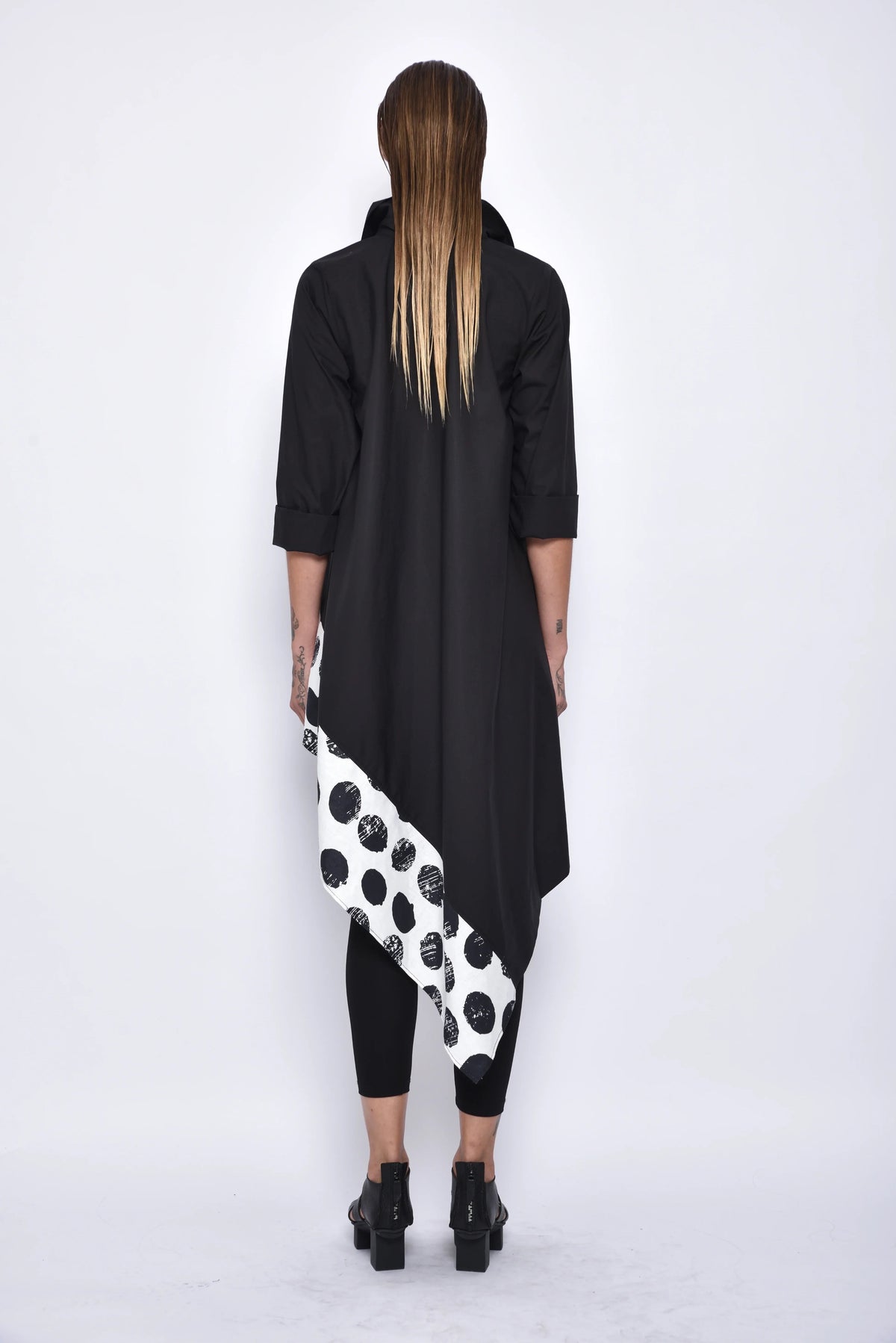Back view of SIMPLY MILA modern women's asymmetrical tunic shirt with long sleeves and stylish drape, casual chic top for women.