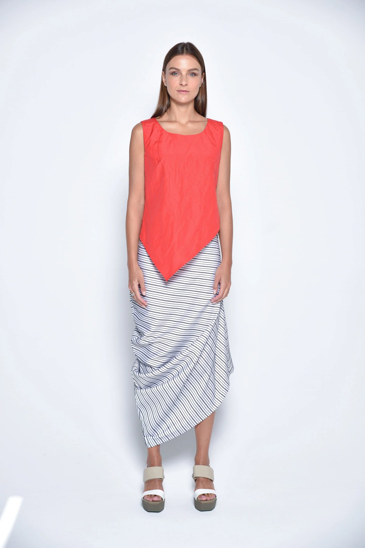 Red uneven hem tank top by SIMPLY MILA, modern women's clothing, featuring a stylish asymmetrical hem and sleeveless design.