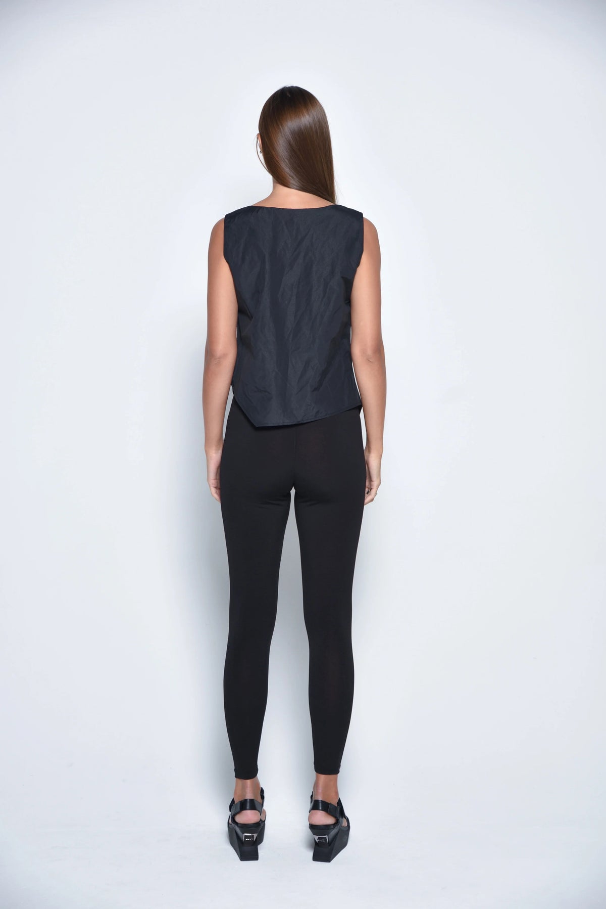 Black uneven hem tank top from SIMPLY MILA Modern Women's Clothing, featuring a relaxed fit and stylish asymmetrical hem.
