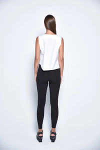 White uneven hem tank top from SIMPLY MILA Modern Women's Clothing, featuring a stylish, asymmetrical hem and sleeveless design.