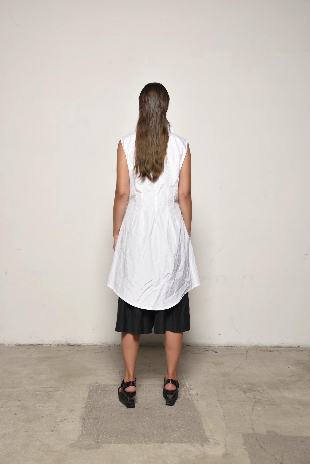Back view of a white Imperial Tunic by SIMPLY MILA, a modern women's clothing piece with a relaxed fit and simple design.