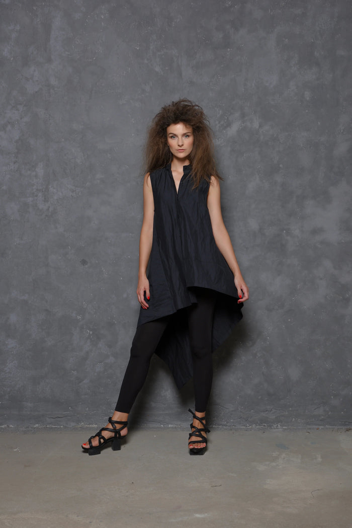 Sleeveless asymmetrical tunic shirt from SIMPLY MILA featuring a modern design and flowing fabric, perfect for casual or stylish wear.
