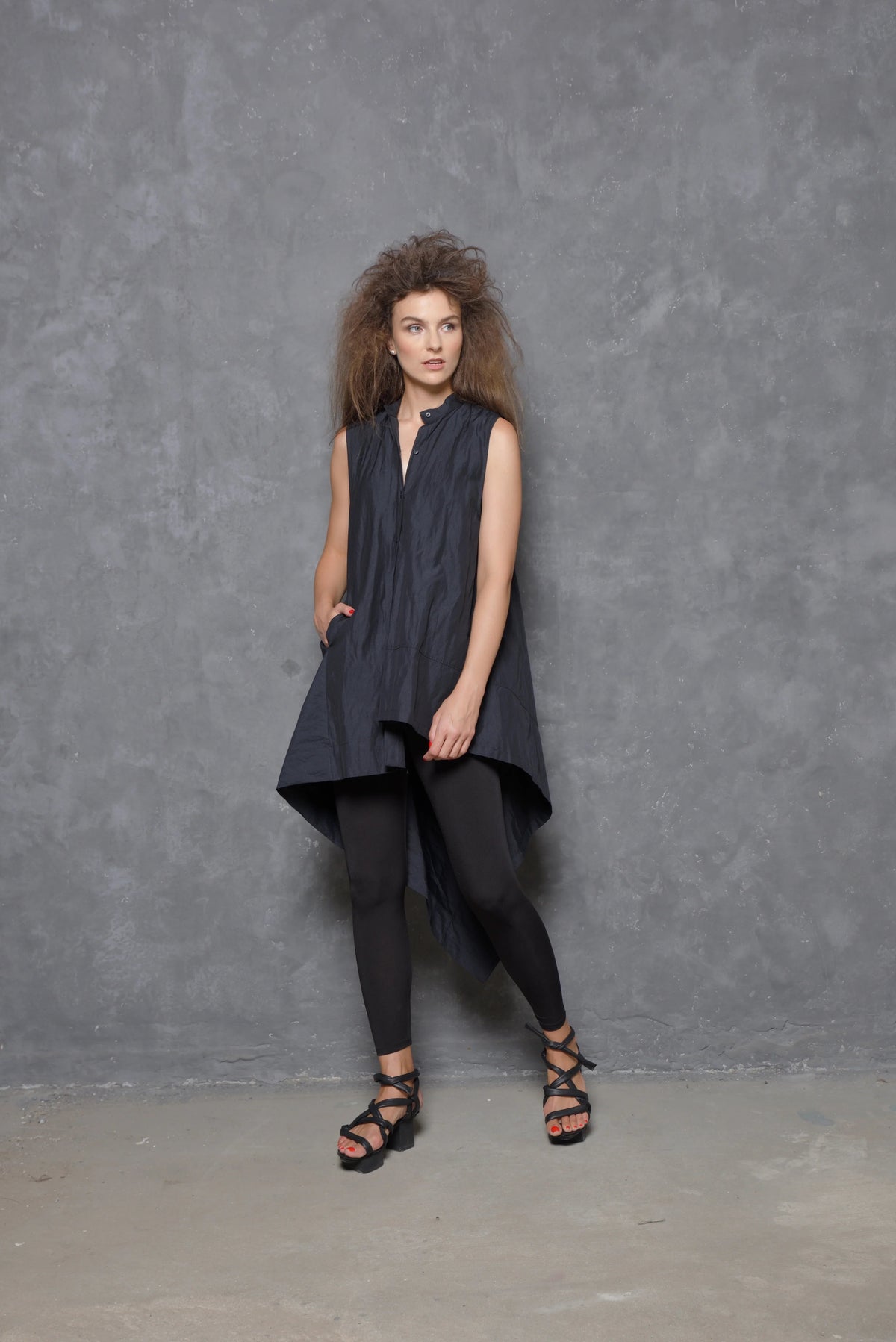 Sleeveless asymmetrical tunic shirt from SIMPLY MILA, featuring a modern design with uneven hem and stylish fit.
