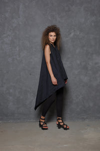 Sleeveless asymmetrical tunic shirt by SIMPLY MILA, displayed in a modern women's clothing style with flowing fabric.