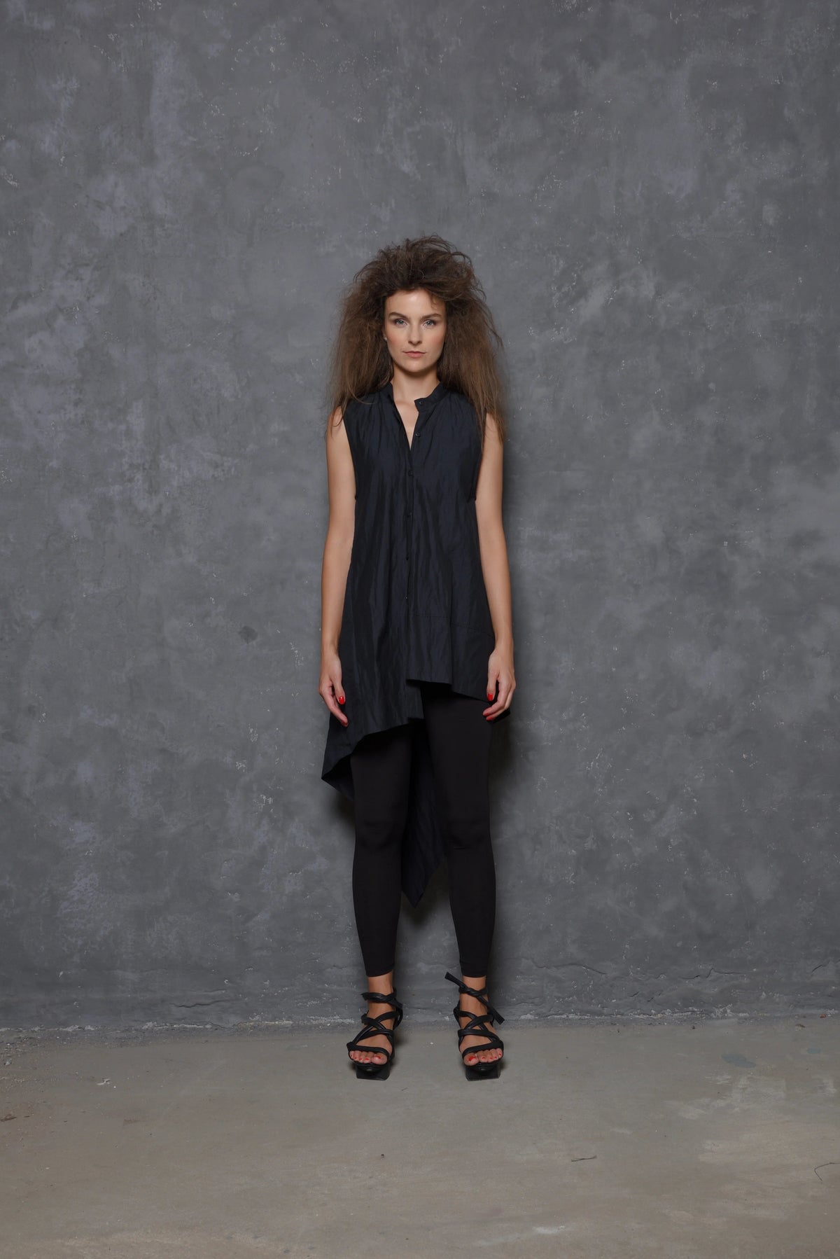 Sleeveless asymmetrical tunic shirt in soft fabric, worn by a woman, showcasing a stylish modern design by SIMPLY MILA.