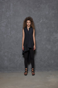Sleeveless asymmetrical tunic shirt in soft fabric, worn by a woman, showcasing a stylish modern design by SIMPLY MILA.