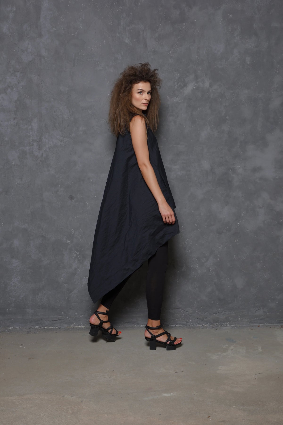 Sleeveless asymmetrical tunic shirt from SIMPLY MILA featuring a modern design, flowy fabric, and stylish silhouette.