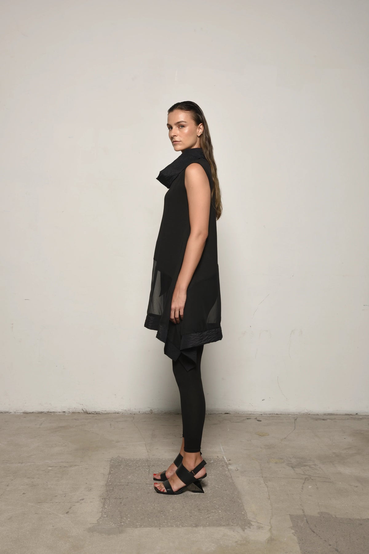 Side view of a sleeveless mix tunic from SIMPLY MILA, showcasing its stylish design and lightweight fabric for modern women's fashion.