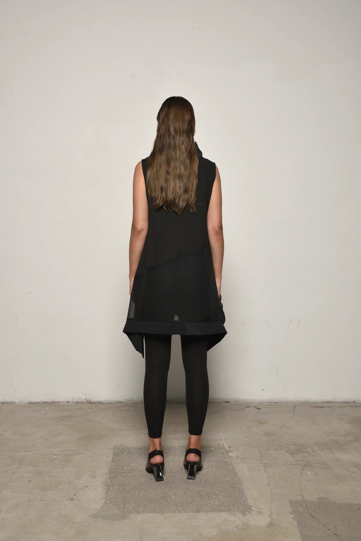 Back view of SIMPLY MILA sleeveless mix tunic, modern women's clothing, soft fabric and stylish design.