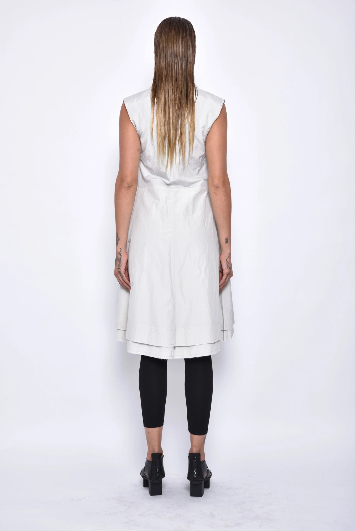 Back view of a stylish SIMPLY MILA modern women's tunic vest, showcasing its tailored fit and sleek design.