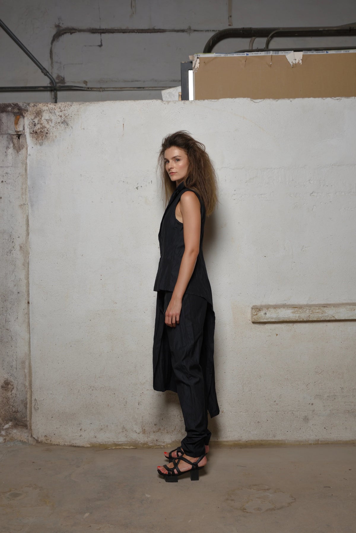 Side view of SIMPLY MILA modern women's uneven vest showing textured fabric and stylish asymmetrical design.