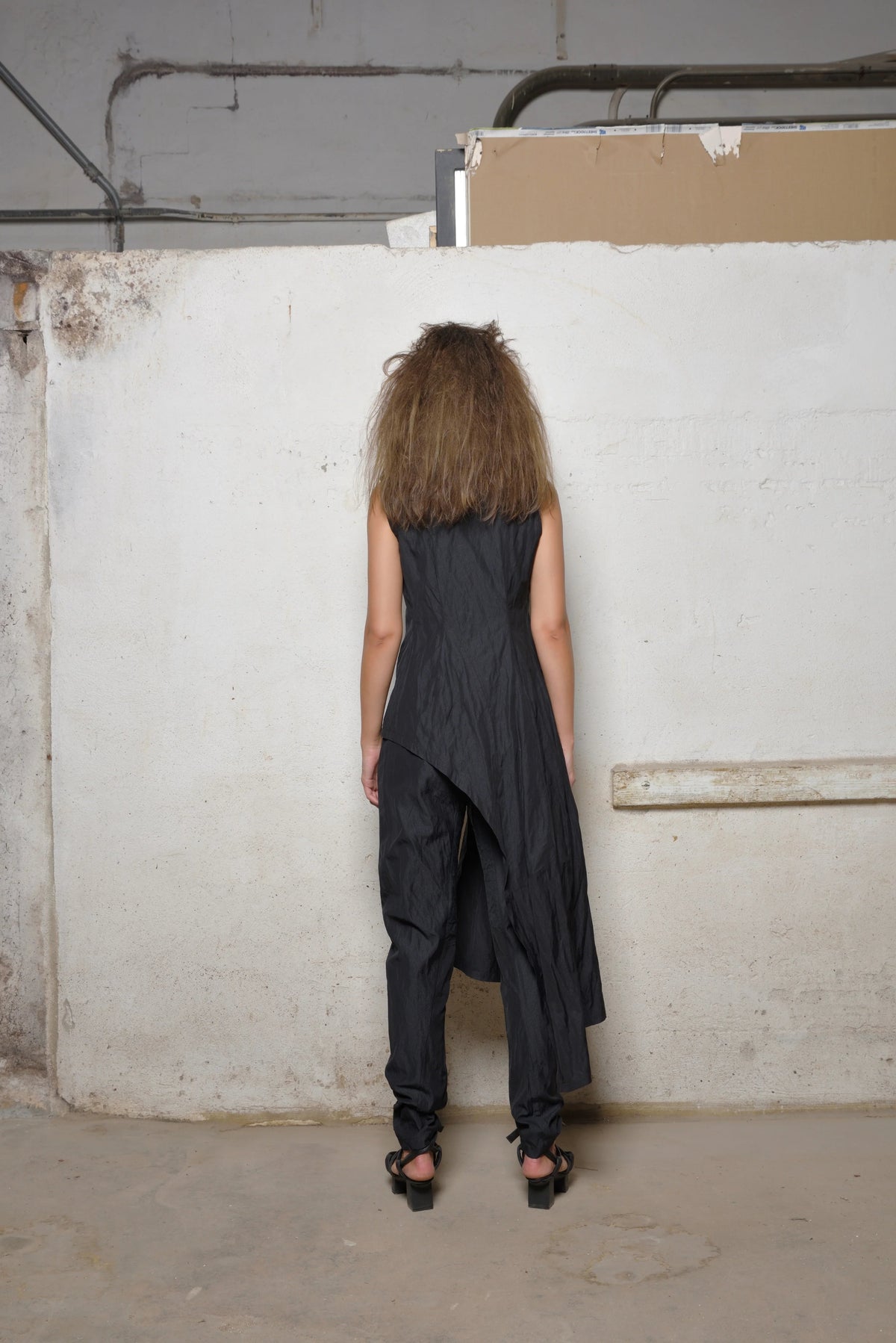 Back view of the stylish uneven vest by SIMPLY MILA, a modern women's clothing piece with asymmetrical design details.