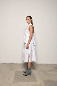 White uneven vest by SIMPLY MILA Modern Women's Clothing, side view showcasing textured fabric and stylish asymmetric design.