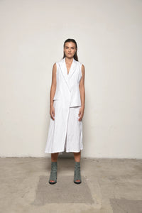 Front view of a white uneven vest by SIMPLY MILA Modern Women's Clothing, featuring asymmetrical hem and stylish design.