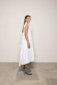 Side view of a white uneven vest by SIMPLY MILA Modern Women's Clothing, showcasing its unique asymmetrical design.