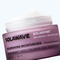 Solawave Pre- & Probiotic Nourishing Moisturizer in a white jar with a silver lid, showcasing its creamy texture and product label.