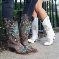 Brown cowgirl boots by Soto Boots with turquoise rose inlay, featuring pointed toes and western stitching details.