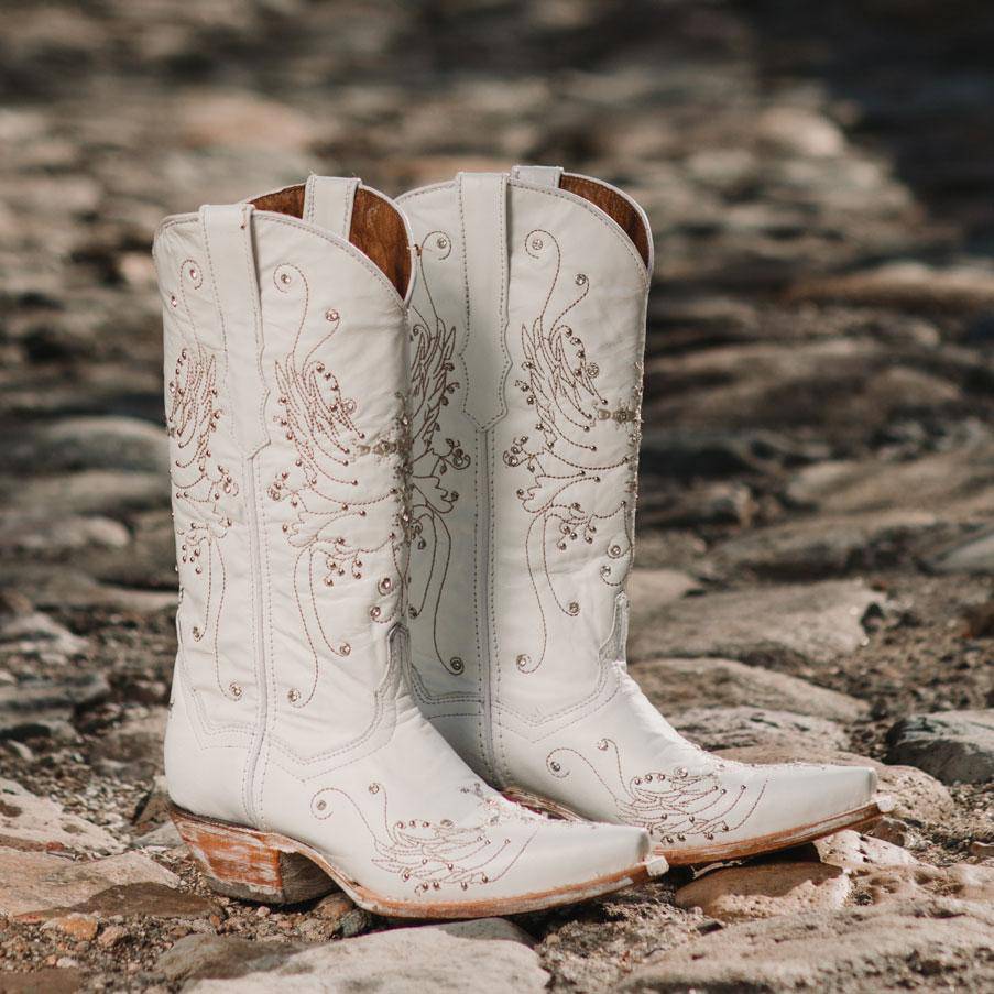White rhinestone cowgirl boots by Soto Boots featuring intricate detailing, perfect for wedding or western style occasions.
