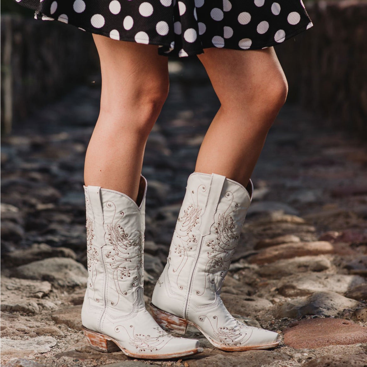 White rhinestone cowgirl boots by Soto Boots featuring pointed toes and decorative stitching, perfect for wedding or Western wear.