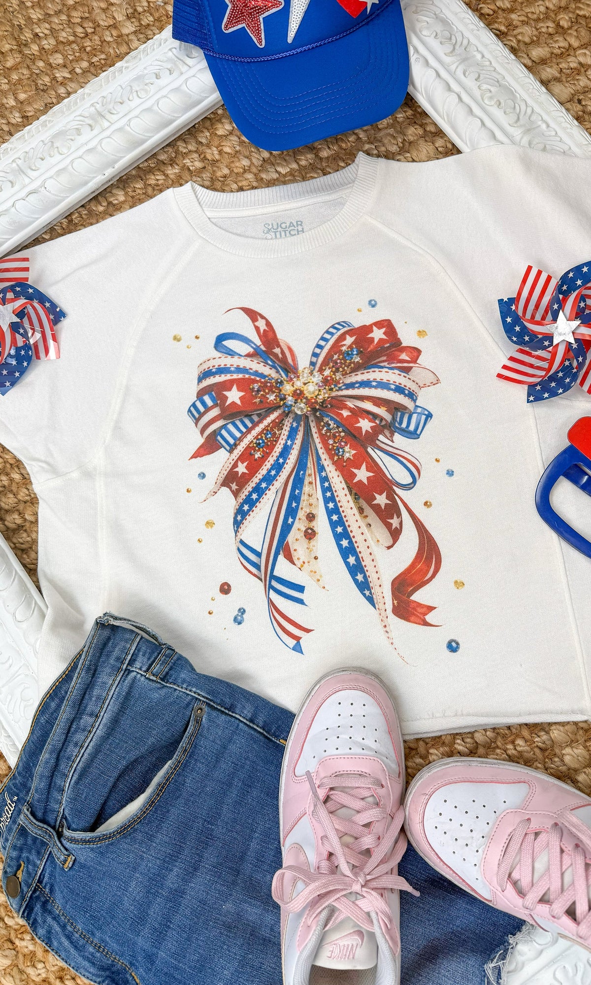 Sugar Stitch Wholesale patriotic ribbon bow graphic shirt featuring a bold, colorful design with a patriotic ribbon bow detail.