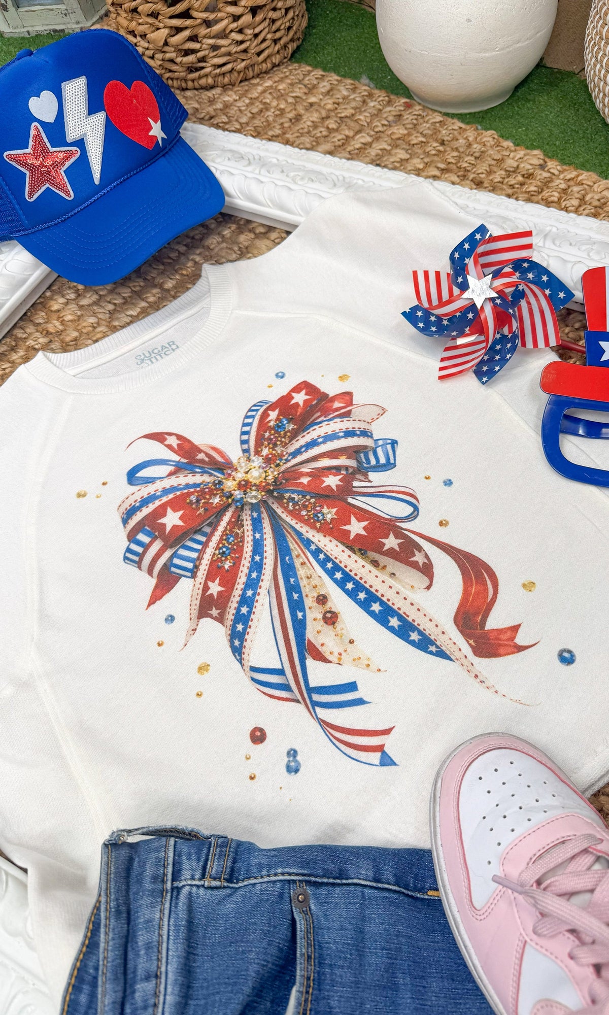 Patriotic Ribbon Bow Edgy Graphic Shirt by Sugar Stitch Wholesale, featuring a bold patriotic design with a ribbon bow detail.
