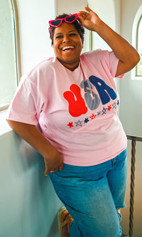 Pink USA graphic T-shirt by Sugar Stitch Wholesale, featuring a bold American flag design on soft cotton fabric.