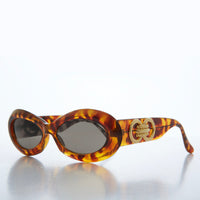 Classic chunky oval women's sunglasses by Sunglass Museum, featuring bold frames and tinted lenses.