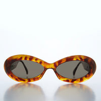 Classic chunky oval women's sunglasses by Sunglass Museum featuring bold frames and dark tinted lenses.