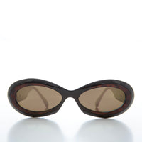 Classic chunky oval women's sunglasses by Sunglass Museum with thick black frames and dark lenses.